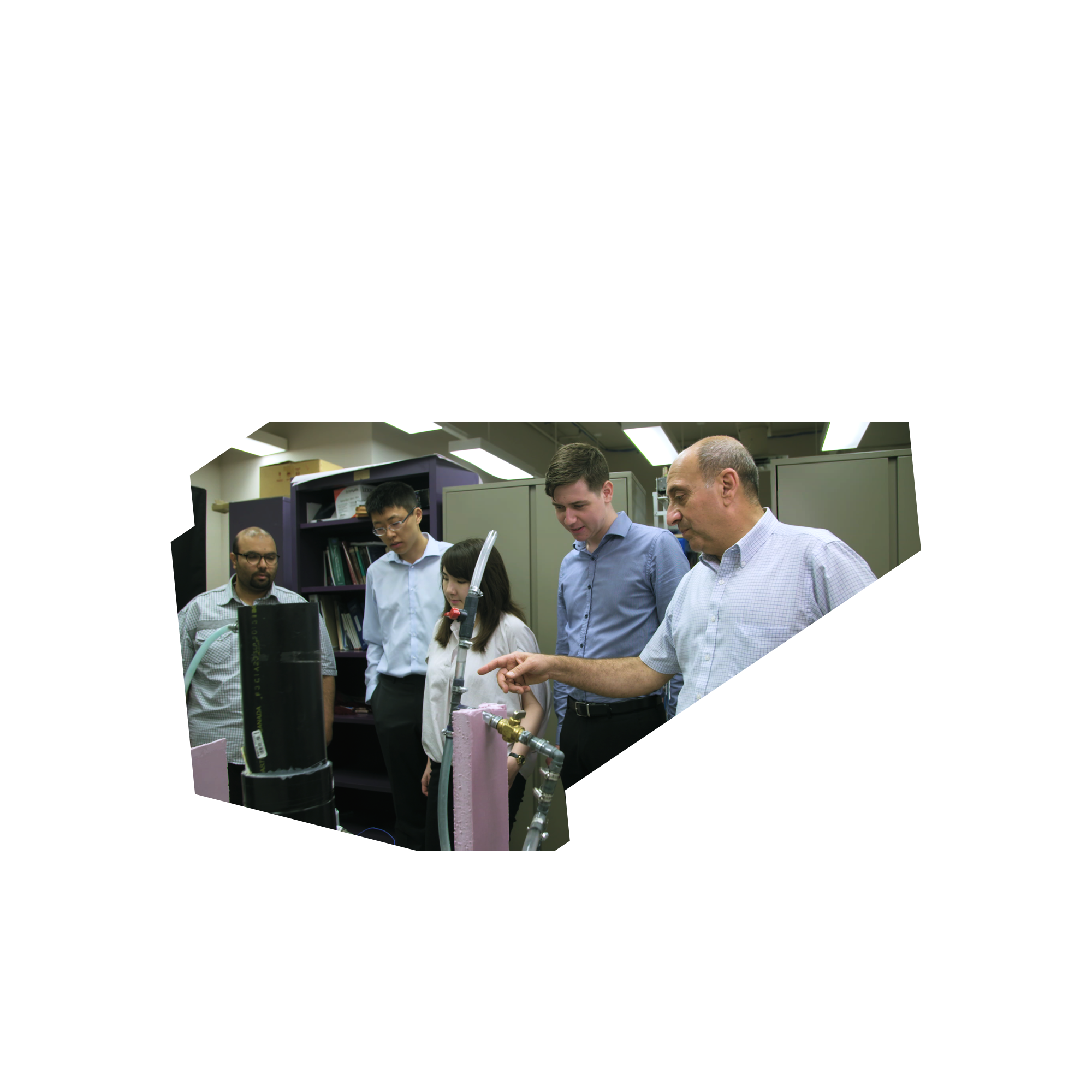 Members of the Ryerson NASA Space Poop Team examine a fluid dynamic model with Ziad Saghir, a professor in Mechanical and Industrial Engineering in the Faculty of Engineering and Architectural Science.