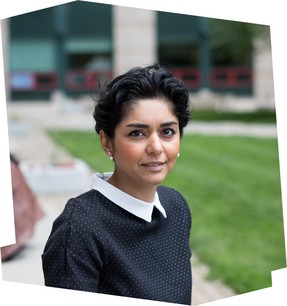 PhD Candidate Parisa Lak sits in her office with two other graduate students.